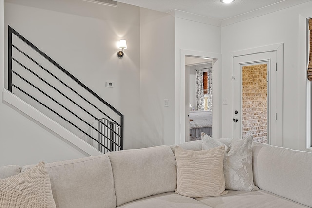 interior space with stairs and ornamental molding