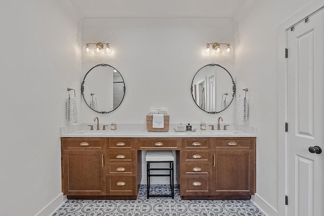 bathroom featuring double vanity, baseboards, and a sink