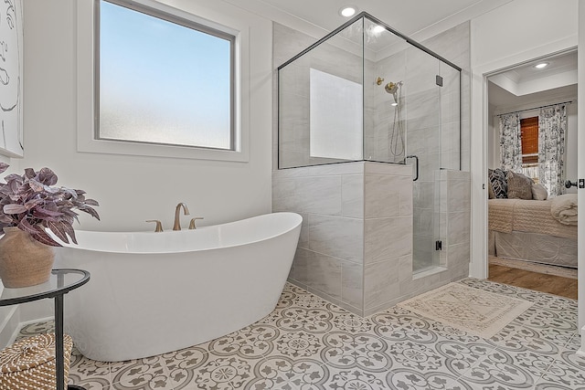 ensuite bathroom with a shower stall, crown molding, recessed lighting, a soaking tub, and ensuite bath