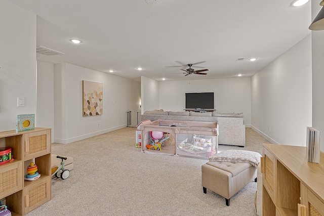 living room with recessed lighting, baseboards, light colored carpet, and a ceiling fan