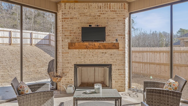 sunroom featuring an outdoor brick fireplace