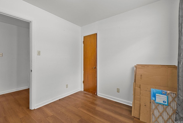 interior space with baseboards and wood finished floors