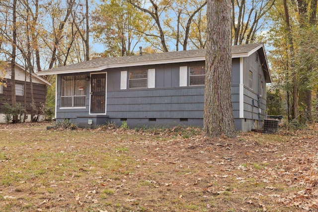 view of front facade with crawl space, central AC, and a sunroom