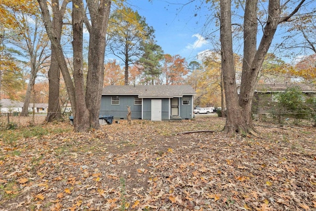 rear view of property with crawl space and fence