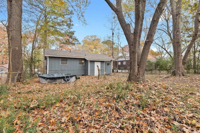 back of property with a trampoline and fence