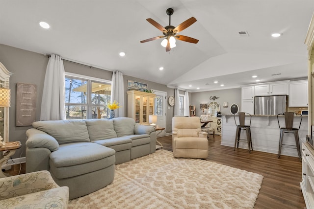 living room featuring vaulted ceiling, recessed lighting, dark wood-style floors, and visible vents