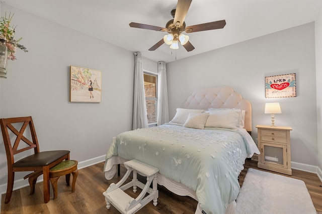 bedroom with baseboards, wood finished floors, and a ceiling fan