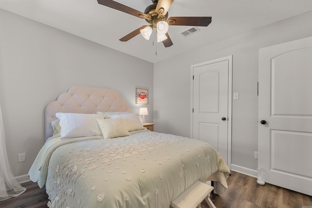 bedroom with visible vents, baseboards, dark wood-type flooring, and ceiling fan