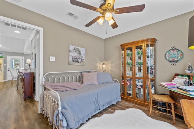 bedroom featuring visible vents, a ceiling fan, and wood finished floors