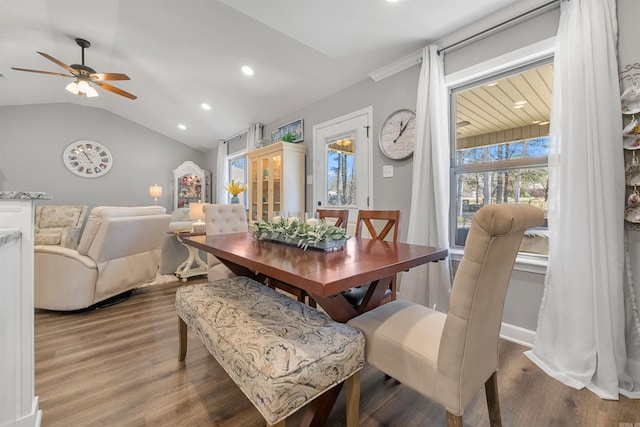 dining room with plenty of natural light, recessed lighting, wood finished floors, and vaulted ceiling