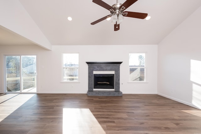 unfurnished living room with a wealth of natural light, lofted ceiling, and wood finished floors