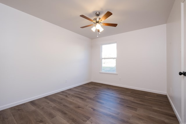 unfurnished room featuring dark wood finished floors, a ceiling fan, and baseboards