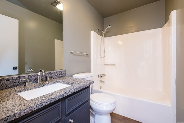 bathroom with visible vents, toilet, shower / bathtub combination, wood finished floors, and vanity