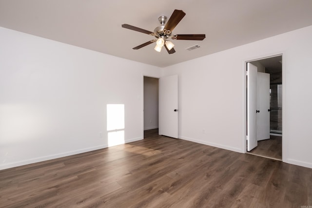 unfurnished bedroom with visible vents, ceiling fan, baseboards, ensuite bath, and dark wood-style flooring