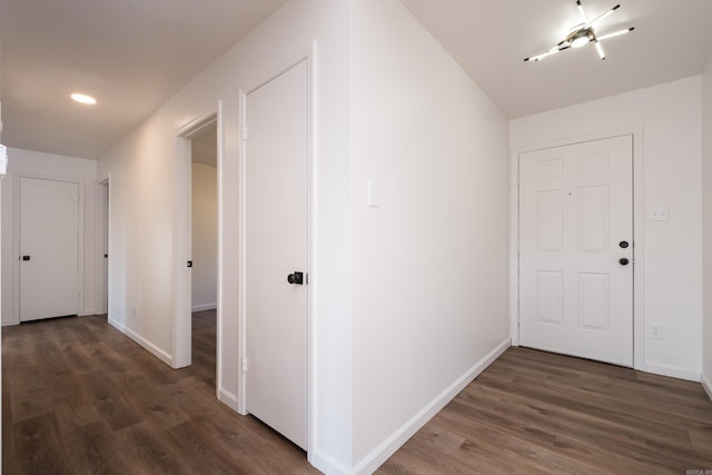 corridor with recessed lighting, baseboards, and wood finished floors