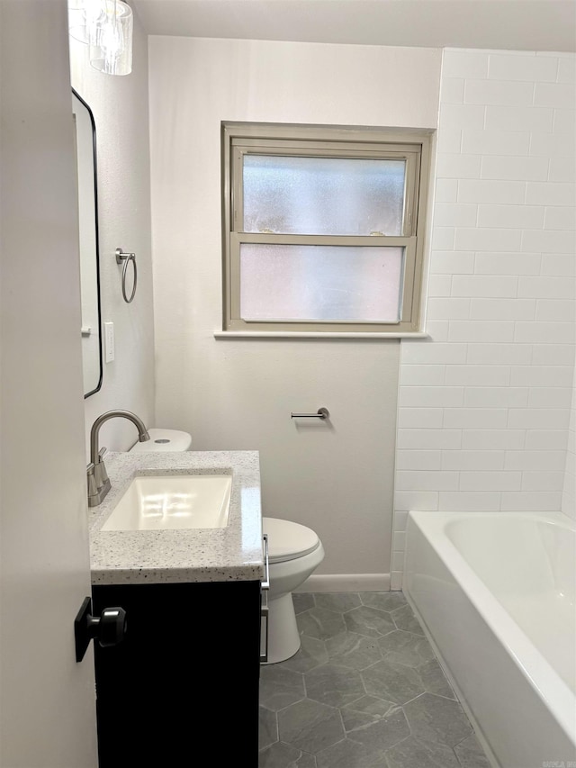 full bathroom featuring vanity, toilet, and baseboards