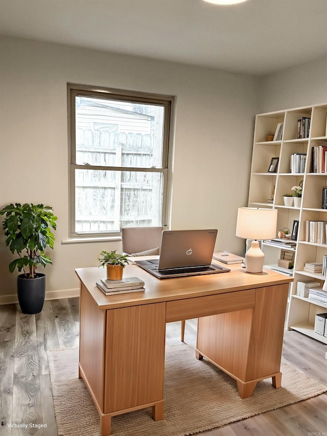 office with light wood-type flooring and baseboards