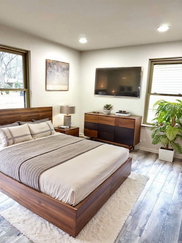 bedroom featuring recessed lighting, wood finished floors, and baseboards