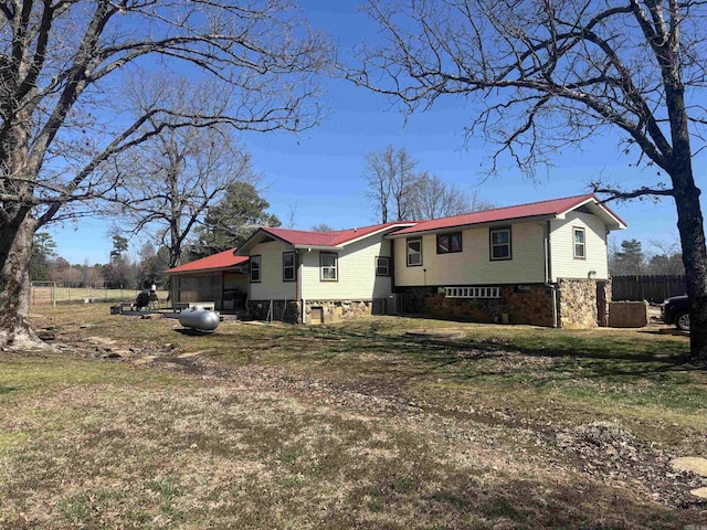 split foyer home featuring metal roof and a front yard