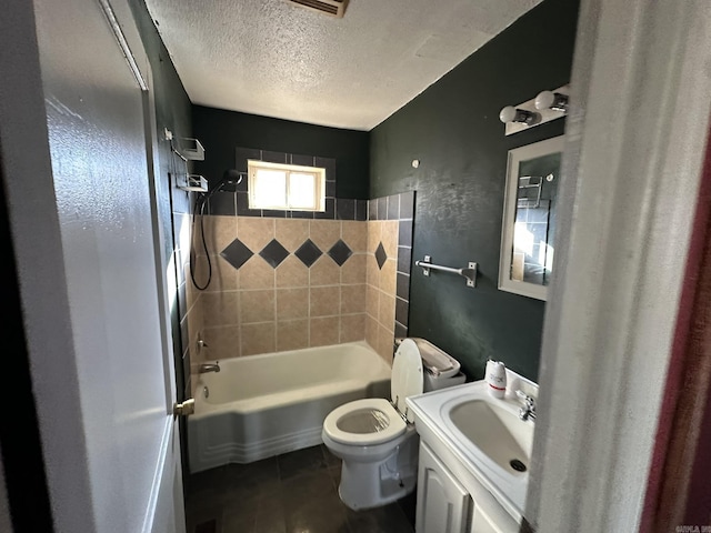 bathroom with vanity, a textured ceiling, shower / tub combination, toilet, and tile patterned floors