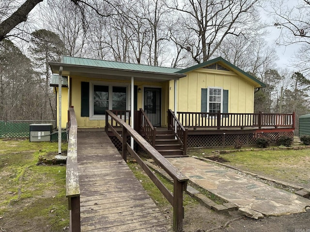 view of front of property with a porch, metal roof, and board and batten siding