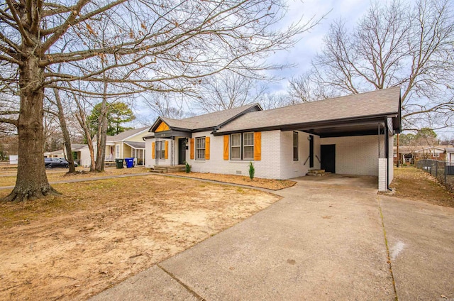 ranch-style home featuring an attached carport, fence, driveway, a shingled roof, and brick siding