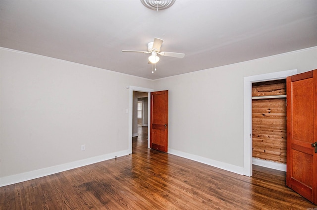 unfurnished bedroom with visible vents, baseboards, dark wood-style floors, and a ceiling fan