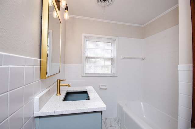 bathroom featuring visible vents, vanity, crown molding, and tile walls