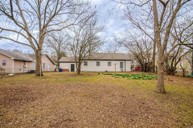 back of house featuring fence