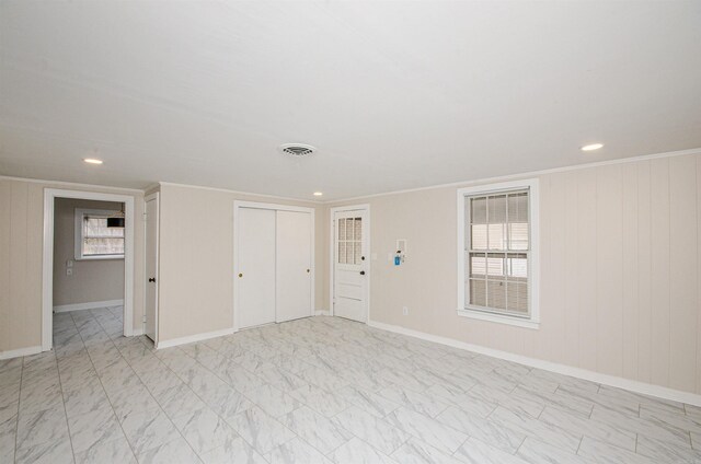 unfurnished room featuring visible vents, baseboards, marble finish floor, and crown molding