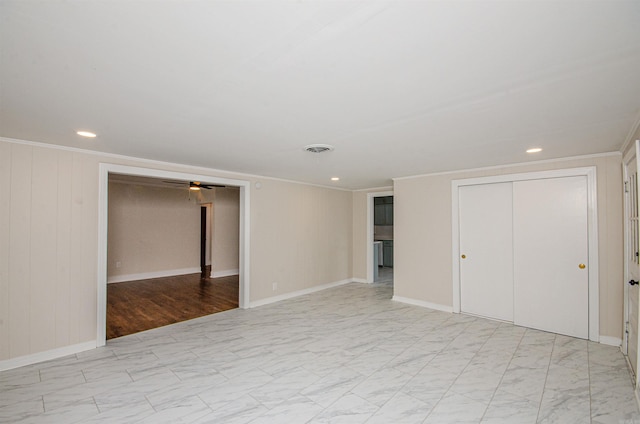 unfurnished room with visible vents, a ceiling fan, marble finish floor, and crown molding