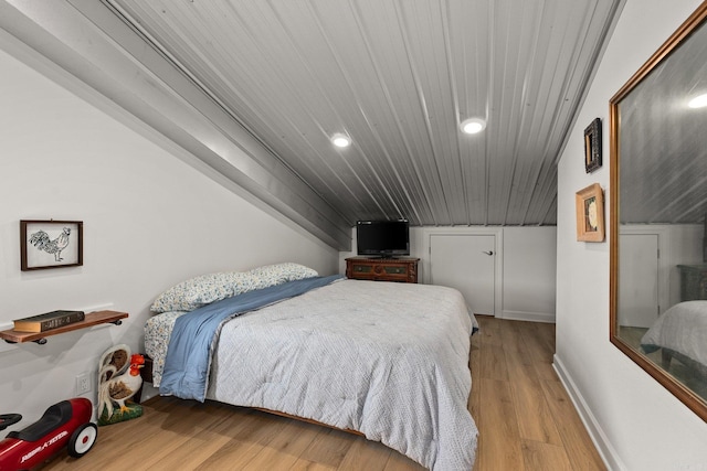 bedroom featuring recessed lighting, baseboards, and wood finished floors