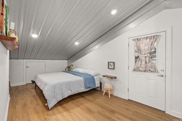 bedroom with baseboards, lofted ceiling, recessed lighting, wood ceiling, and light wood-type flooring