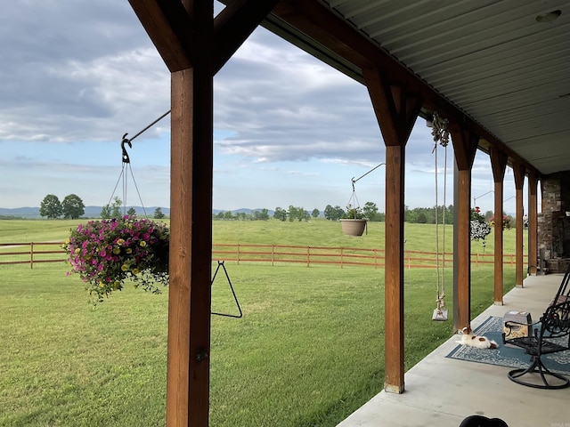 view of yard featuring a rural view and fence