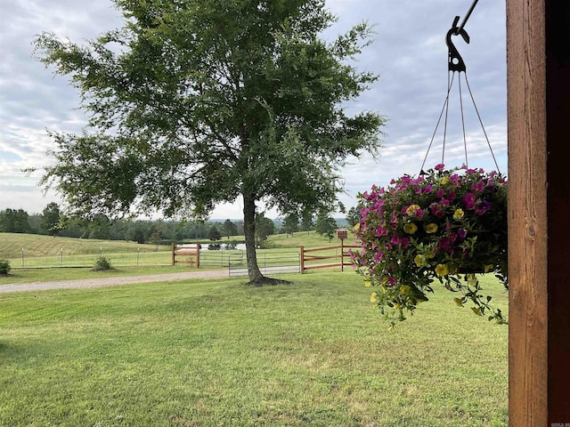 view of yard with a rural view and fence