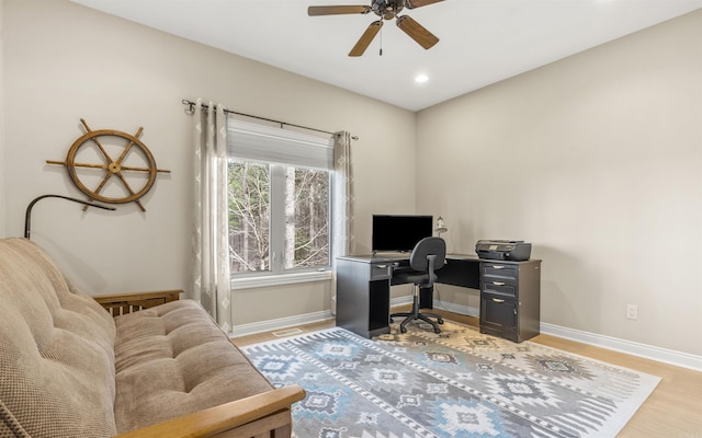 office space featuring a ceiling fan, recessed lighting, light wood-style floors, and baseboards