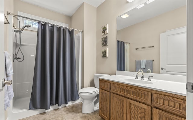 bathroom with tile patterned flooring, a shower with curtain, toilet, and vanity