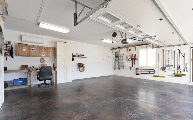 garage featuring a garage door opener, a wall mounted AC, and baseboards