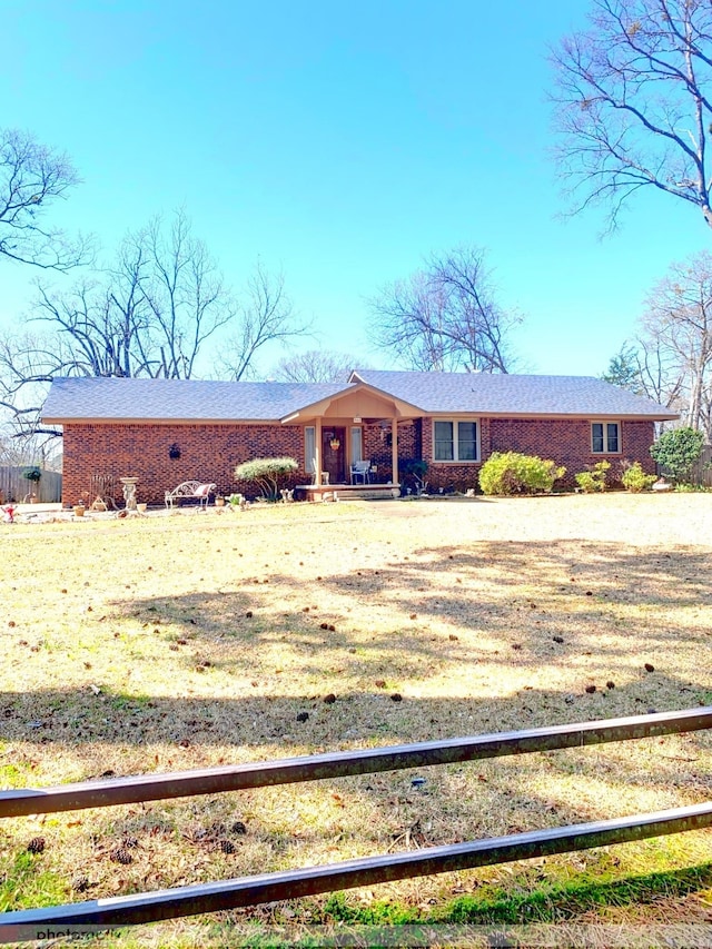 single story home featuring brick siding