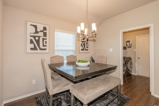 dining room with lofted ceiling, independent washer and dryer, a chandelier, and dark wood-style flooring