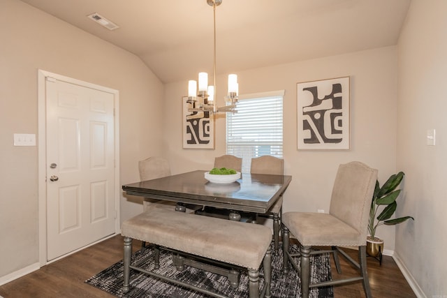 dining space with visible vents, dark wood-type flooring, baseboards, lofted ceiling, and a notable chandelier