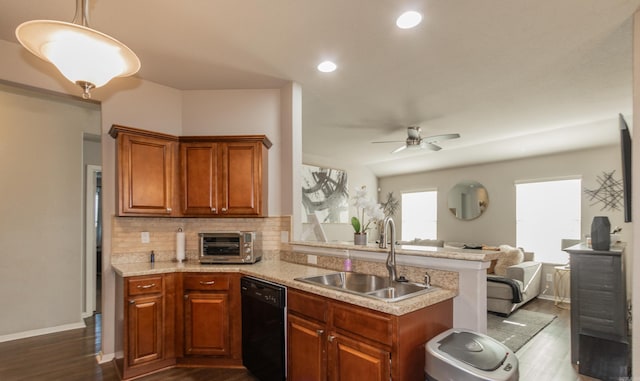 kitchen with a toaster, open floor plan, dishwasher, light countertops, and a sink