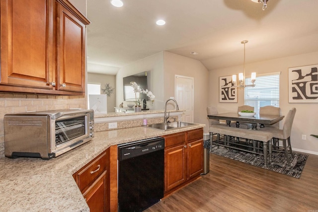 kitchen with a peninsula, black dishwasher, dark wood-style floors, and a sink