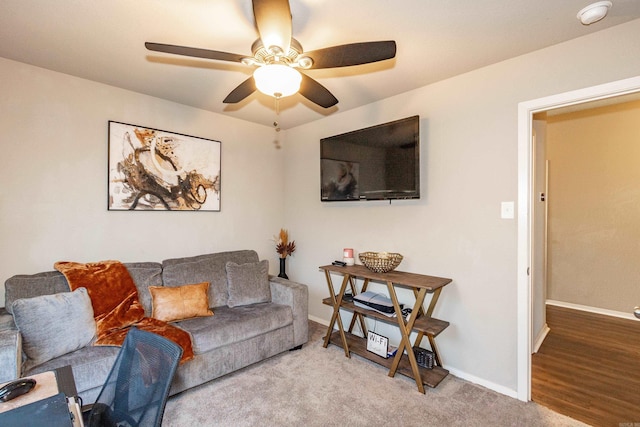 carpeted living room with baseboards and ceiling fan