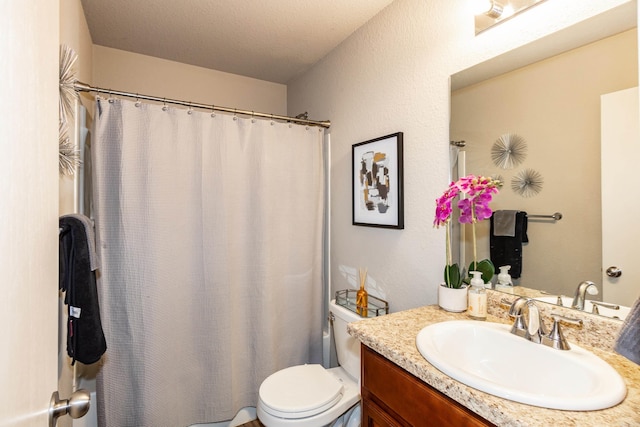 full bath with toilet, curtained shower, vanity, and a textured ceiling