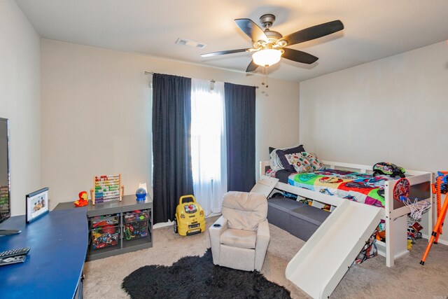 bedroom featuring a ceiling fan, visible vents, and carpet floors