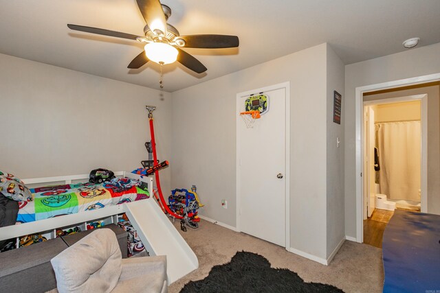 carpeted bedroom featuring baseboards and a ceiling fan