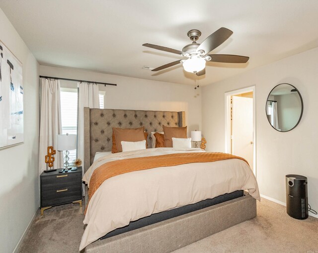 carpeted bedroom featuring baseboards and ceiling fan