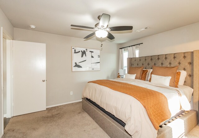 bedroom featuring visible vents, baseboards, a ceiling fan, and carpet floors