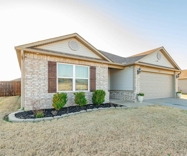 ranch-style home featuring fence, an attached garage, concrete driveway, a front lawn, and brick siding